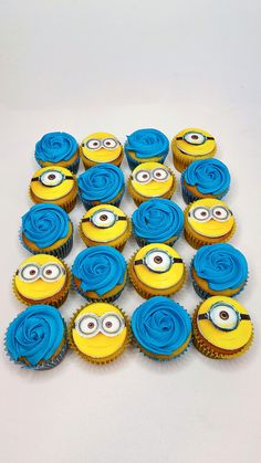 a bunch of cupcakes with blue frosting in the shape of a minion