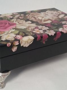 a black box with pink and white flowers on it