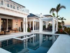 a house with a pool in front of it