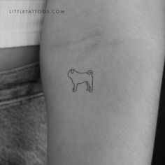 a small dog tattoo on the left arm