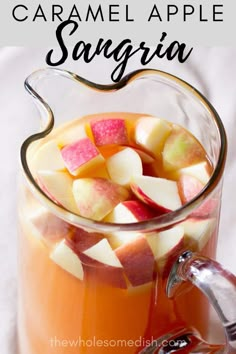 a pitcher filled with liquid and sliced apples