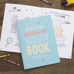 wedding activity book next to colored pencils and crayons on wooden table top