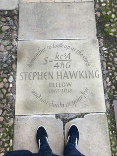 a person standing in front of a plaque on the ground that reads stephen hawking