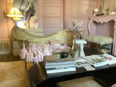 a living room with pink walls and furniture