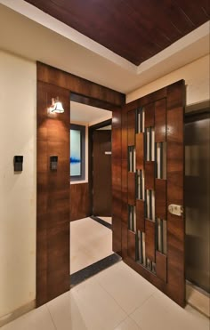 an empty room with wooden doors and white tile flooring on either side of the door