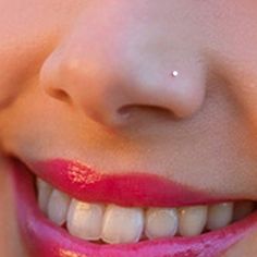 a close up of a woman's face with pink lipstick