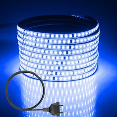 an image of a blue led strip light on a dark background with the cord plugged in