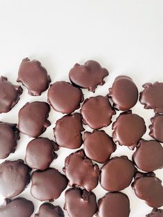 chocolate hearts are arranged on a white surface