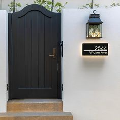 a black front door with a light on it