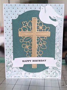 a card with a cross and dove on it