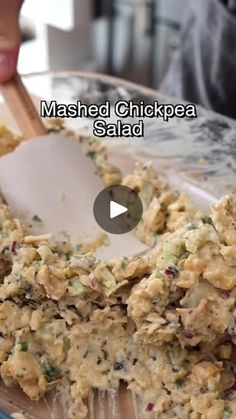 a video showing how to make mashed chickpea salad on a glass platter