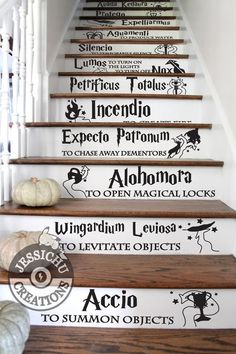 the stairs are decorated with black and white wall decals, as well as pumpkins