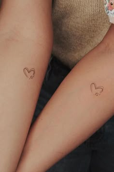 two people with matching tattoos on their arms