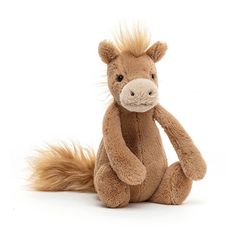 a small stuffed horse sitting on the ground