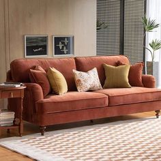 a living room scene with focus on the couch and rug, which has been placed in front of a window