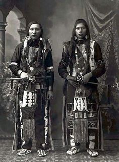 two native american men standing next to each other