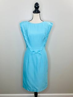 "Vintage Original Lilli Diamond or California Blue Woven Midi Sheath Pencil Dress with Statement Shoulders Bow Details and Back Zipper Closure Women Tag Labeled  as a 12 but measurements are closer to a Modern 6/Small (Please See Measurements Below) Wedding Guest 50s 60s Twee Hipster Good Condition, Minor Flaw: Small Blue Mark, Please See Pictures For Details Bust: 17.5\" Waist: 14.25\" Hips: 18.5\" Shoulder to Hem: 41.25\"" 1950s Cocktail Dress, Hostess Dresses, Picnic Dress, Mock Neck Dress, Full Skirt Dress, Nightgowns For Women, Mini Tank Dress, Black Velvet Dress, Lace Dress Black