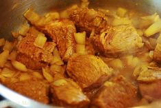 meat and onions cooking in a pot on the stove