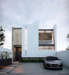 a car is parked in front of a modern house