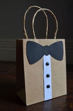 a paper bag with a bow tie on it