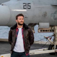 a man standing in front of an airplane