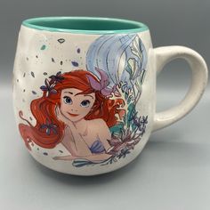 the little mermaid mug is decorated with an image of ariel