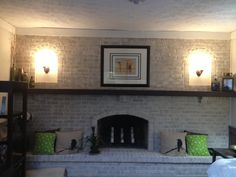 a living room filled with furniture and a fire place in front of a brick wall