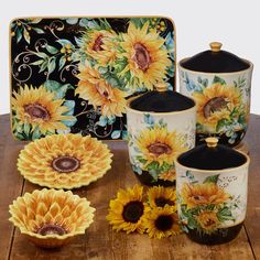 the sunflowers are painted on ceramic dishes and cups, along with other decorative items