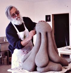 an older man is working on a sculpture