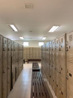 rows of lockers lined up in an empty room with no one sitting on the bench