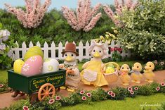 an easter scene with eggs in a wagon and two little chicks sitting on the ground