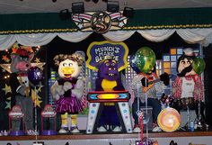 the stage is set up for a children's birthday party with balloons and decorations