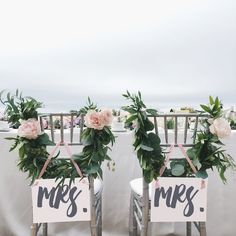 two chairs decorated with flowers and mr and mrs signs