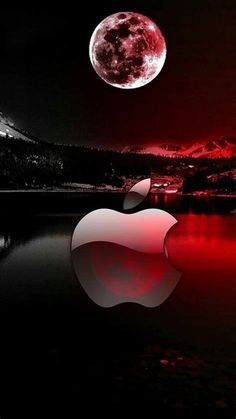 an apple logo is shown in front of a full moon and mountain range at night