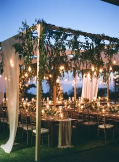 an outdoor wedding setup with candles and greenery