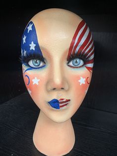 a mannequin head with an american flag painted on it's face and blue eyes