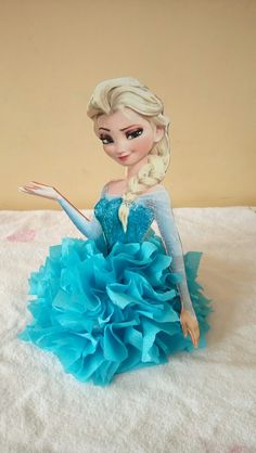 a frozen princess doll sitting on top of a bed