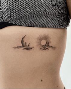 a woman's stomach with two birds flying in the sky and sun on it