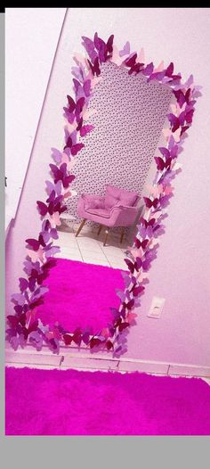 there is a mirror with purple butterflies on it in the room that has pink carpet