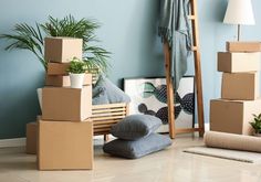 cardboard boxes stacked on top of each other in front of a blue wall and floor