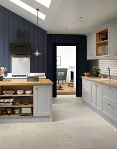 a kitchen with blue walls and white cabinets