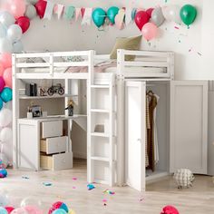 there is a loft bed with a desk underneath it and balloons all around the room