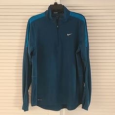 Nwot Nike 1/4 Zip Dri-Fit Long Sleeve Running Shirt Size Medium Teal (Hard To Capture Exact Color But It Is A Dark Teal. Last Photo Is The Best Match) 100% Polyester Very Lightweight. Whole Body Of Shirt Is Vented Fabric Nwot Condition Blue Stretch Shirt For Fall, Nike Fitted Long Sleeve Tops, Blue Fitted Half-zip Top, Fitted Half-zip Tops For Layering, Nike Half-zip Winter Top, Nike Winter Half-zip Top, Nike Stretch Winter Tops, Nike Fitted Winter Tops, Winter Nike Stretch Tops