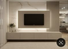 a living room with a large tv mounted on the wall