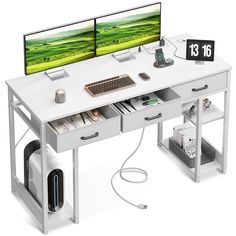 two computer monitors sitting on top of a white desk