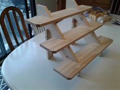 a wooden shelf sitting on top of a white table