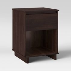 a dark wood nightstand with one drawer open