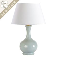 a light blue lamp with a white shade on it