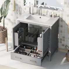 a bathroom sink sitting under a mirror next to a white counter top with drawers underneath it