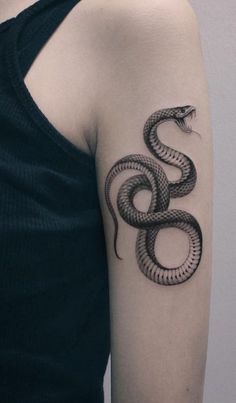 a woman with a snake tattoo on her arm